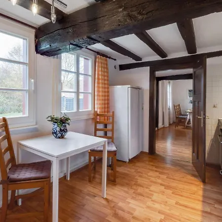 A Lovely Watermill Surrounded By Delightful Greenery